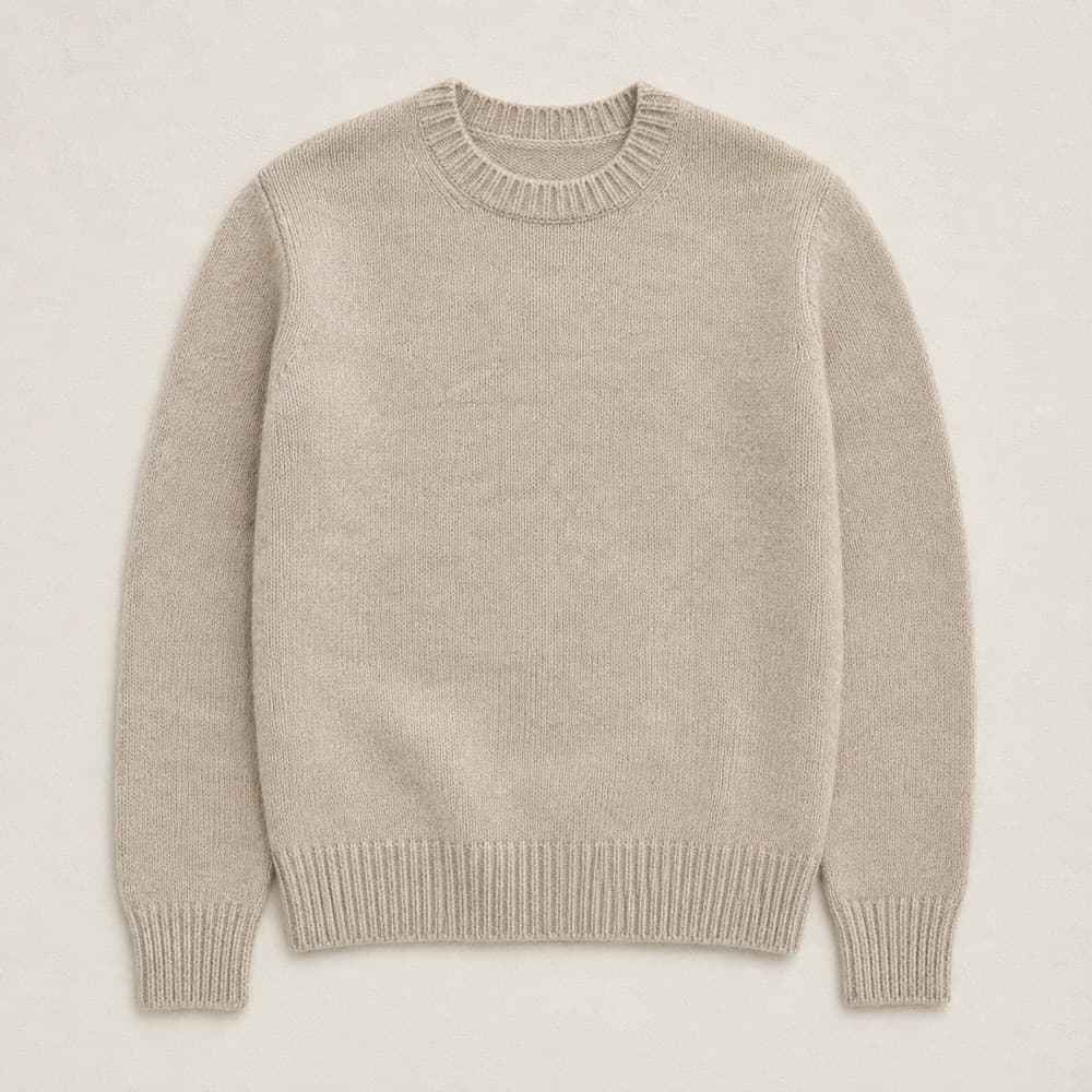 Heavy cashmere jumper, laid flat. Step 1: Face the jumper down. Fold the left body edge inward along a vertical line 3 cm outside the armhole seam.