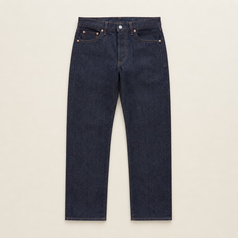Raw denim jeans, laid flat and photographed from above.
