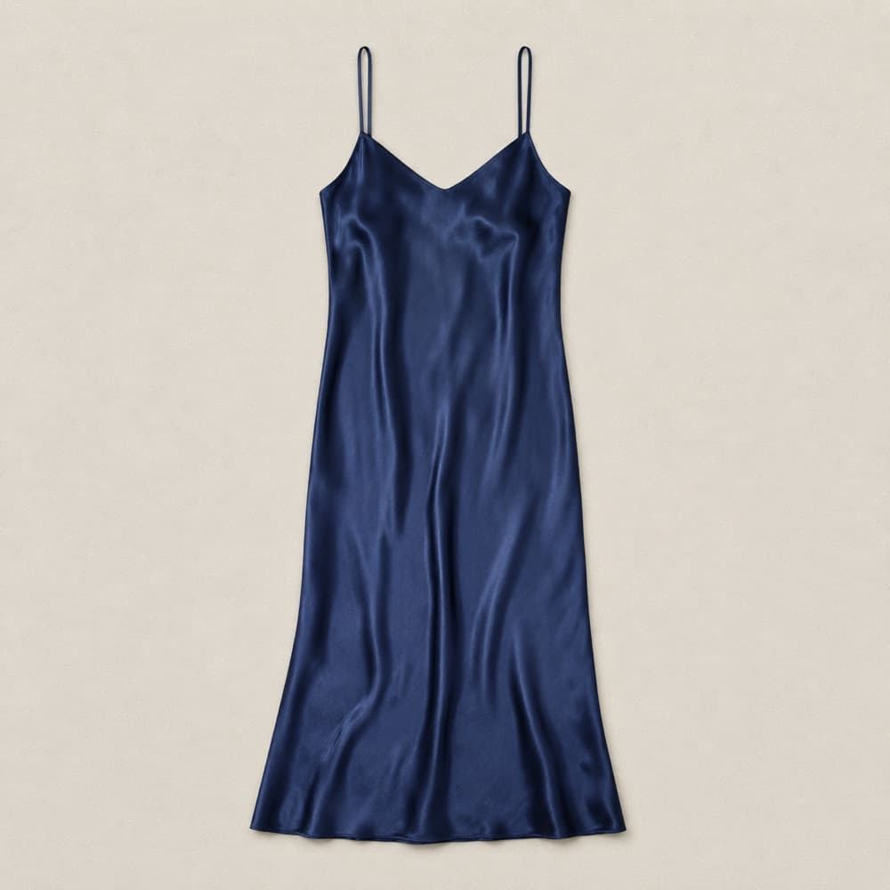 Silk slip dress, laid flat and photographed from above.